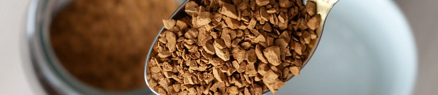 closeup instant coffee granules on spoon